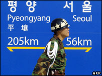 South Korean soldier passes sign at Dorasan railway station, near   North-South frontier