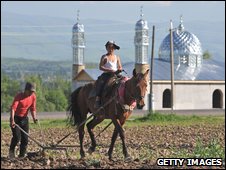 Brothers ploughing a field in Kyrgyzstan