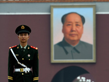 Paramilitary policemen stands guard near portrait of late Chinese   leader Mao Tse-Tung