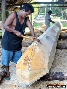 Islander carves traditional dugout canoe